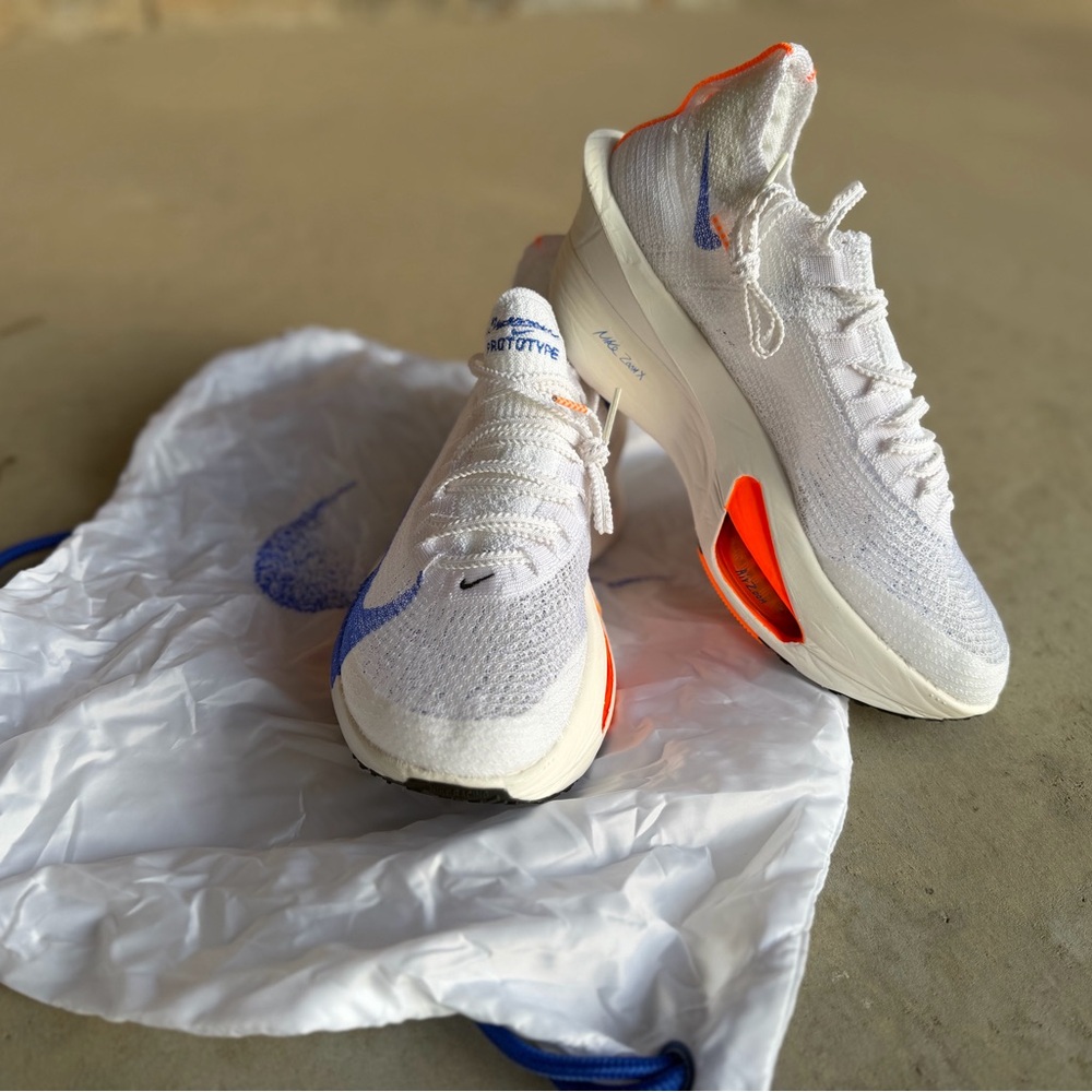Nike Women's White Athletic Running Shoes with Blue and Orange Accents